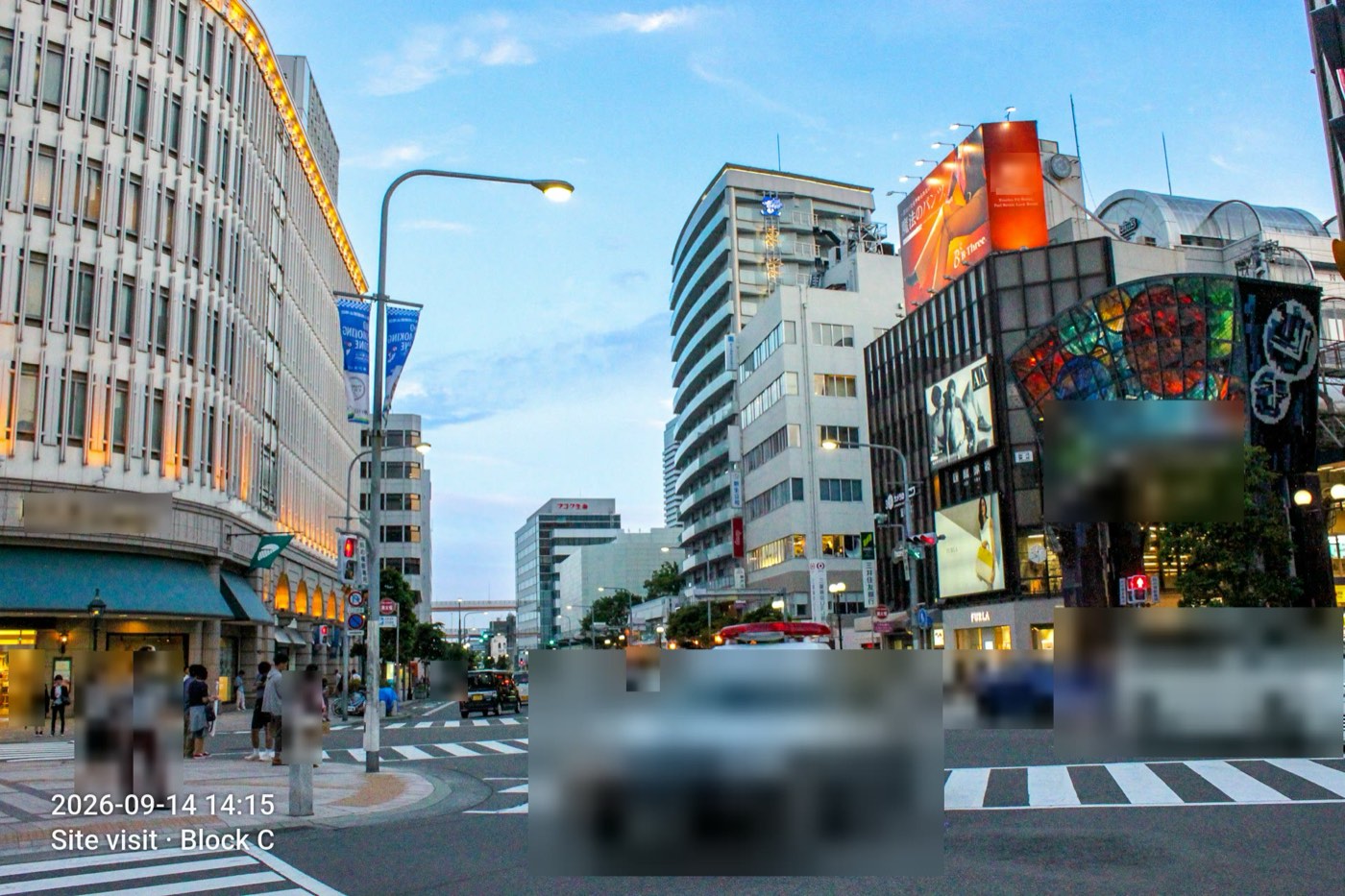A second redacted street scene, faces and vehicles blurred.